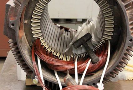 A large electric motor in the midst of a repair.