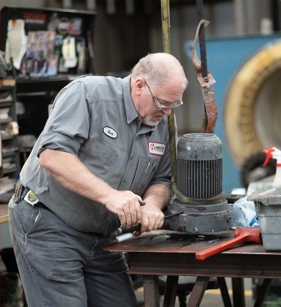 HECO worker disassembling a small electric motor.