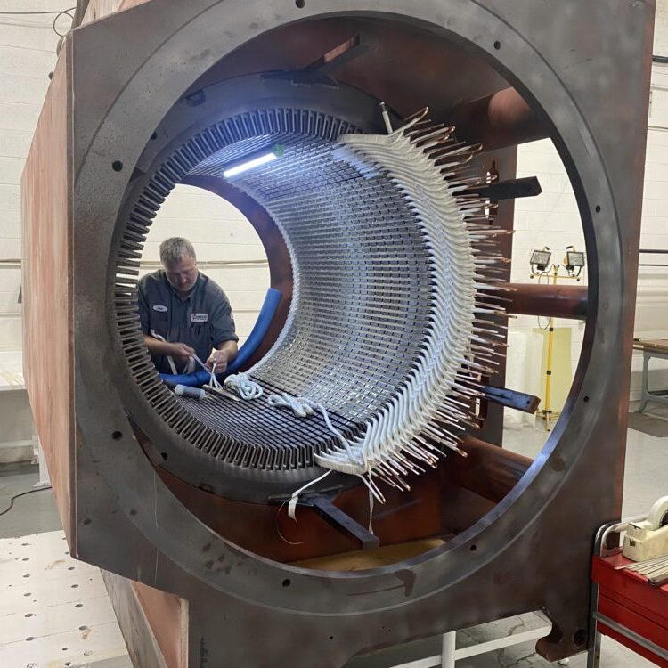HECO technician working on a high voltage motor in a clean room