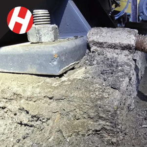 A motor sitting on a crumbling concrete foundation.